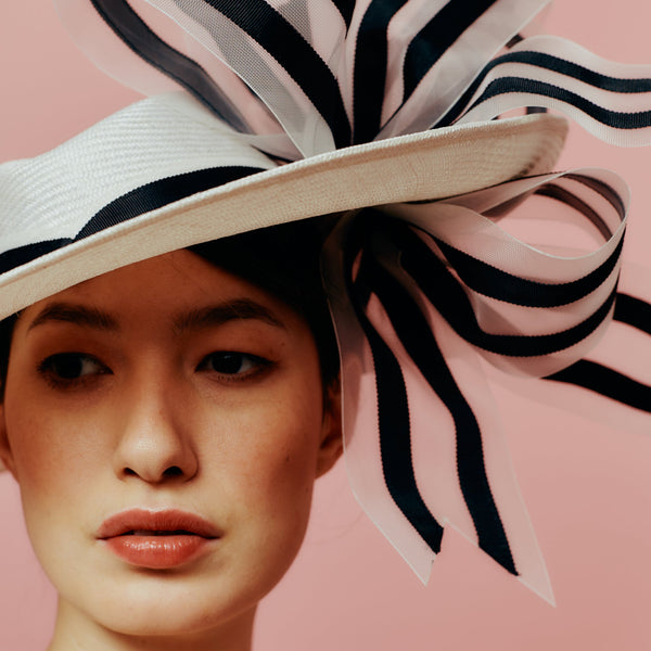 white straw slice fedora with black and white bow