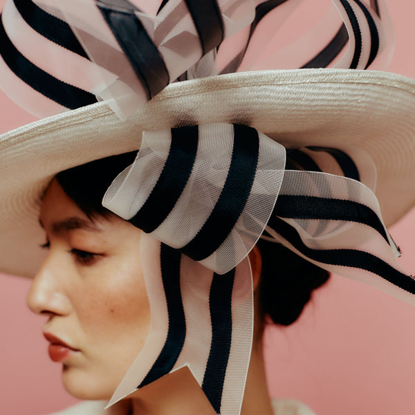 white straw slice fedora with black and white bow