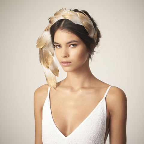 This Awon Golding Millinery sculptural veil is made from ivory tulle, ostrich quills, dramatic pheasant feathers, and gold ombr_ goose feathers.