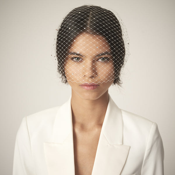 This Awon Golding Millinery sculptural veil is made from ivory tulle, ostrich quills, dramatic pheasant feathers, and gold ombre goose feathers.
