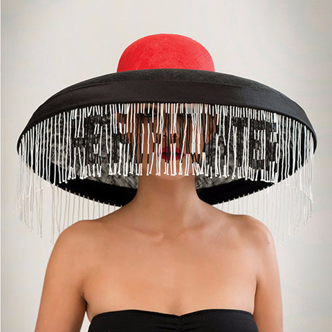 Headhunter - Sinamay & pinokpok wide brim hat with satin bias band and hand-beaded trim. This statement hat features traditional Naga colours.