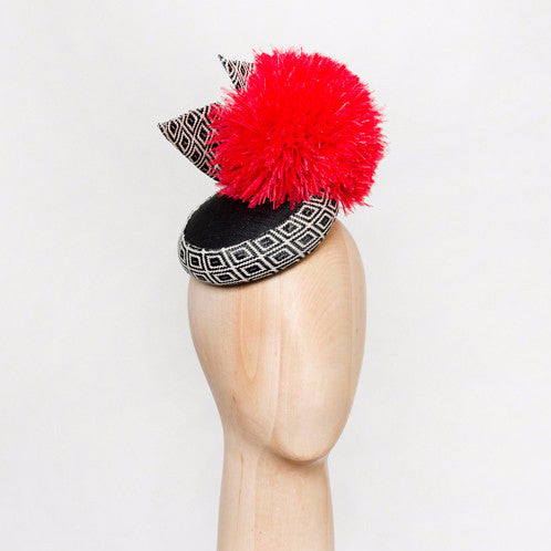 Sema - Pinokpok & geo-woven fabric base with giant ostrich pom pom. 