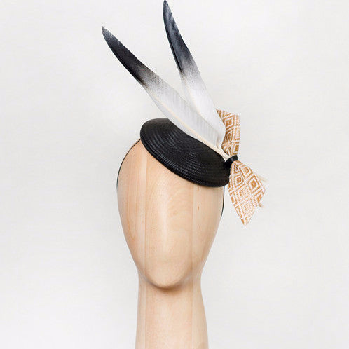 Ash - This black straw disc with goose feathers and geo-woven gold fabric bow is a crowd-pleaser that goes with almost anything.