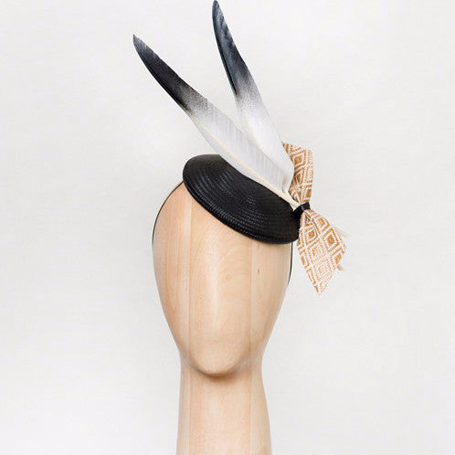 Ash - This black straw disc with goose feathers and geo-woven gold fabric bow is a crowd-pleaser that goes with almost anything. 