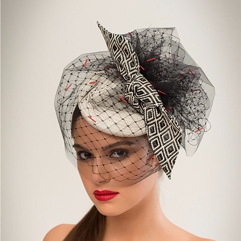 Rivers - White straw disc with geo-woven bow & hand-beaded tulle veil. This hat is both demure and modern. 