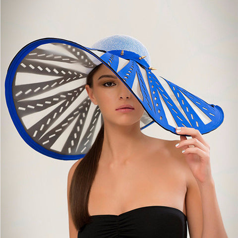 Manipur - Cobalt laser-cut neoprene and crinoline brim sunhat with brass spike trim band, and french net and silk crown. Wear this to the beach or to the races, either way you're making an entrance.
