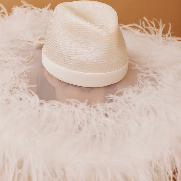 White straw hat with a white feathered brim