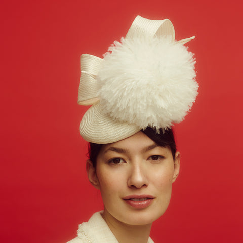 Awon Golding Ivory white straw button hat with giant ostrich pom pom and straw bow at the back. modern millinery