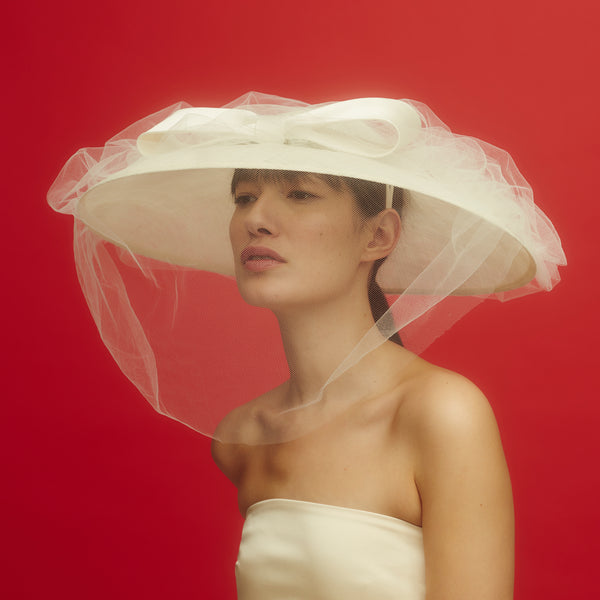 Awon Golding wide brim bridal hat with tulle veil and duchess satin bow. upward view