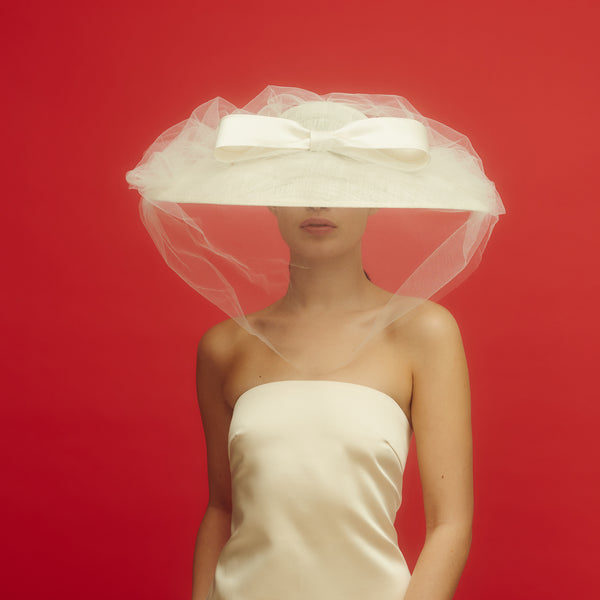 Awon Golding wide brim bridal hat with tulle veil and duchess satin bow