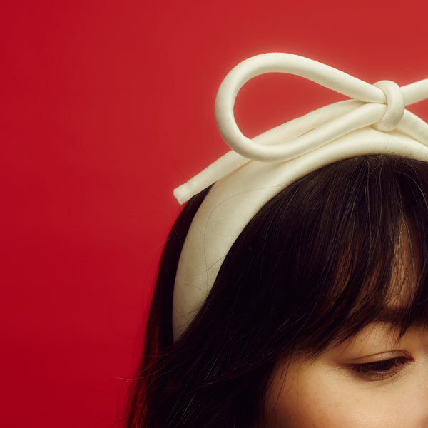 Awon Golding ivory white bridal headband with bow. close up