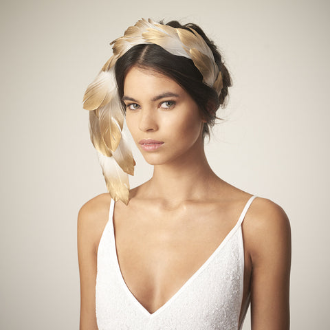 This Awon Golding Millinery sculptural veil is made from ivory tulle, ostrich quills, dramatic pheasant feathers, and gold ombr_ goose feathers. 