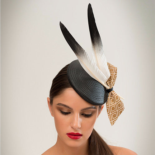 Ash - This black straw disc with goose feathers and geo-woven gold fabric bow is a crowd-pleaser that goes with almost anything. 